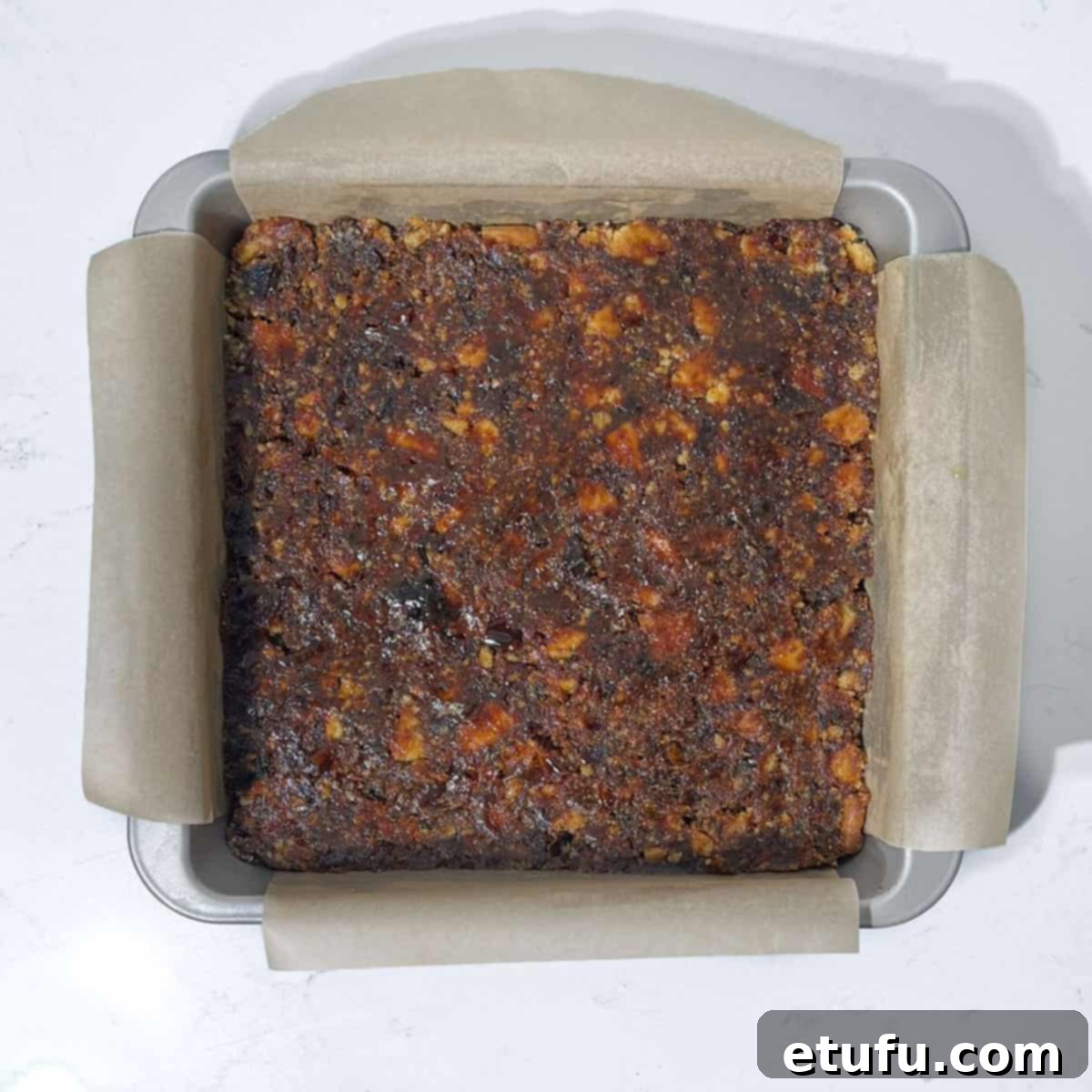 Effortless Date Bars 17 The date squares mixture firmly pressed and leveled in the square tin, ready for chilling.