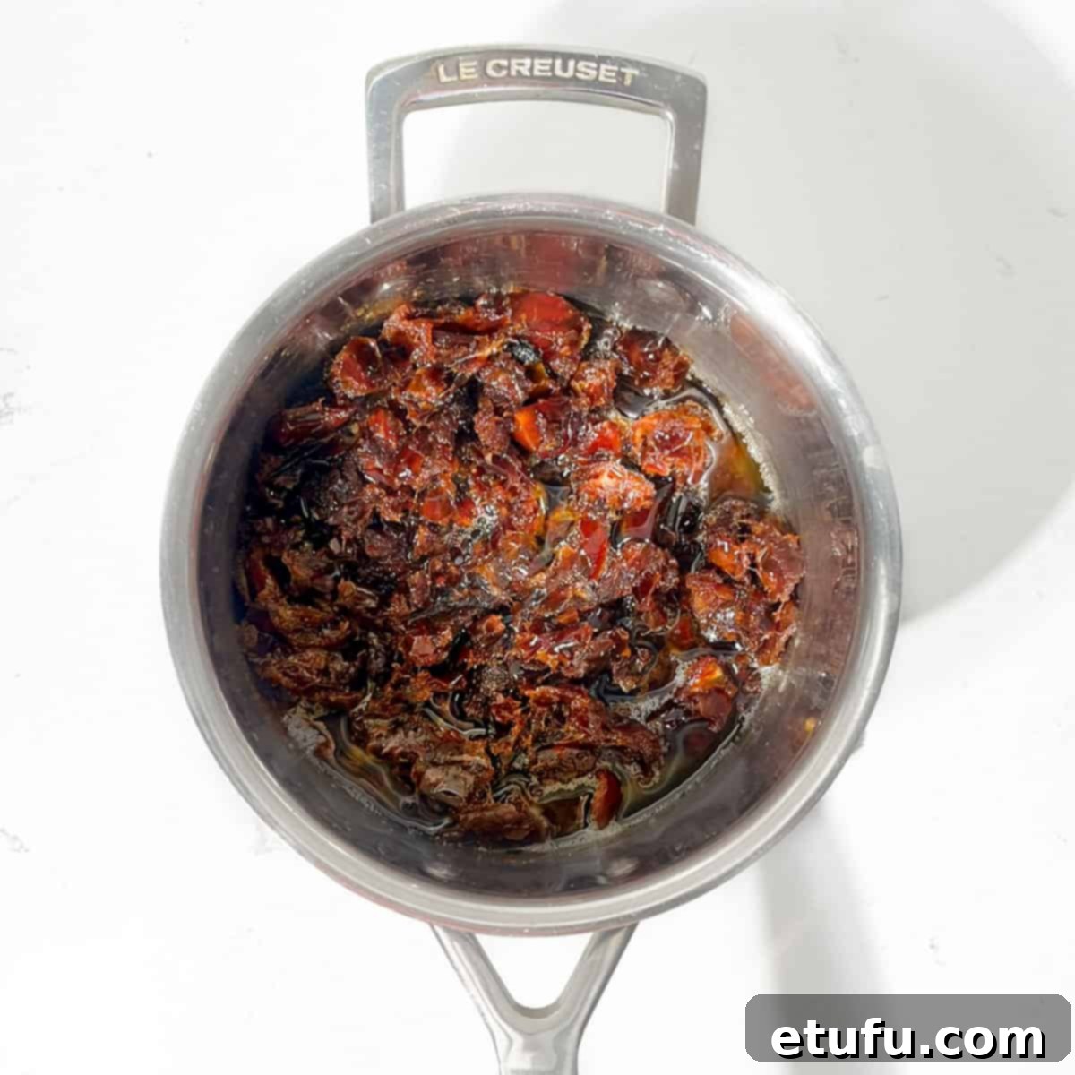 Effortless Date Bars 7 Chopped dates simmering in melted butter within a large saucepan.