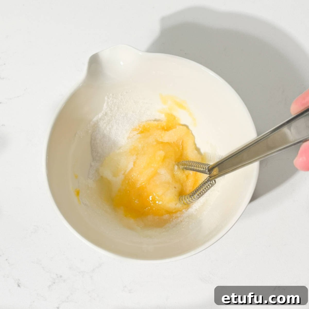 Effortless Date Bars 9 A small whisk blending egg, sugar, and salt in a bowl until combined.