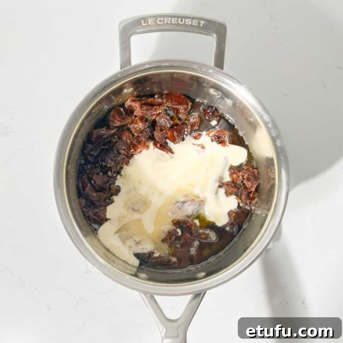 Effortless Date Bars 10 Adding the whisked egg and sugar mixture into the cooked dates in a saucepan.