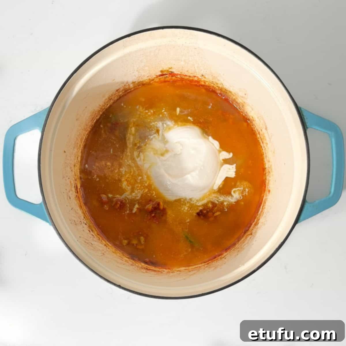 Adding coconut milk to the large saucepan.