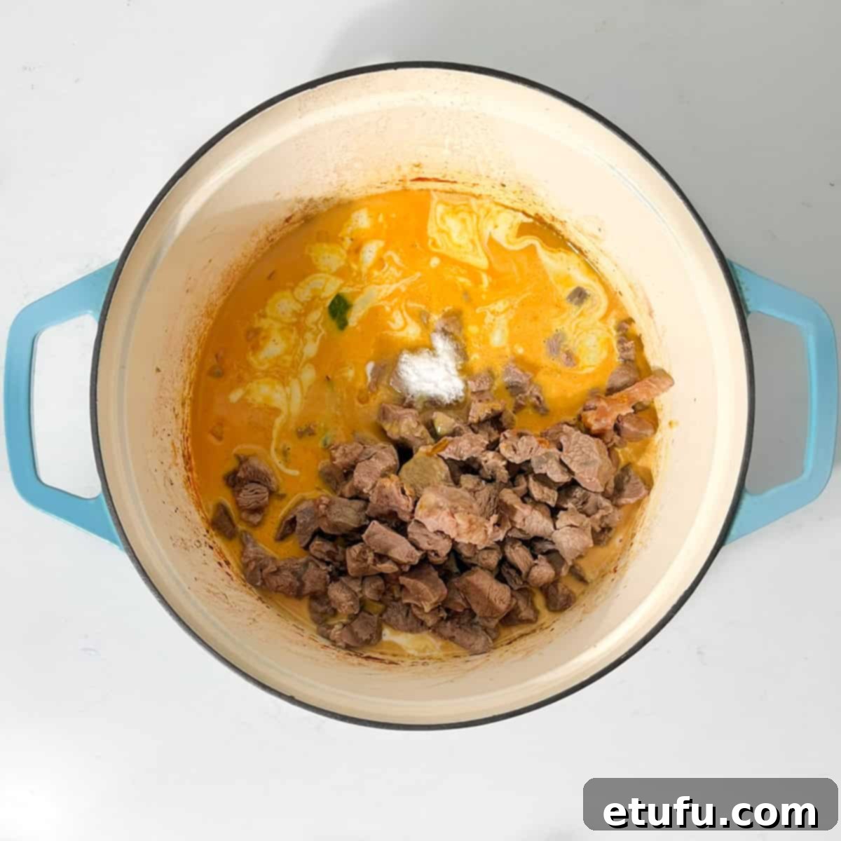 Adding the beef back into the pot for the beef curry with coconut milk.