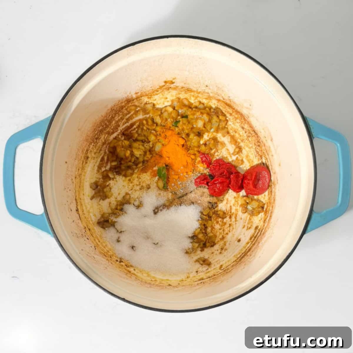 Adding all the spices to the saucepan for the beef curry.