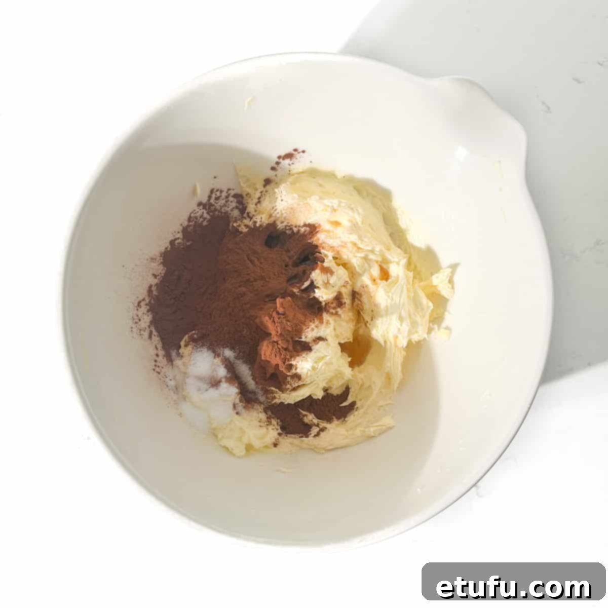 Adding cocoa powder to the butter and sugar mixture for the chocolate shortbreads.