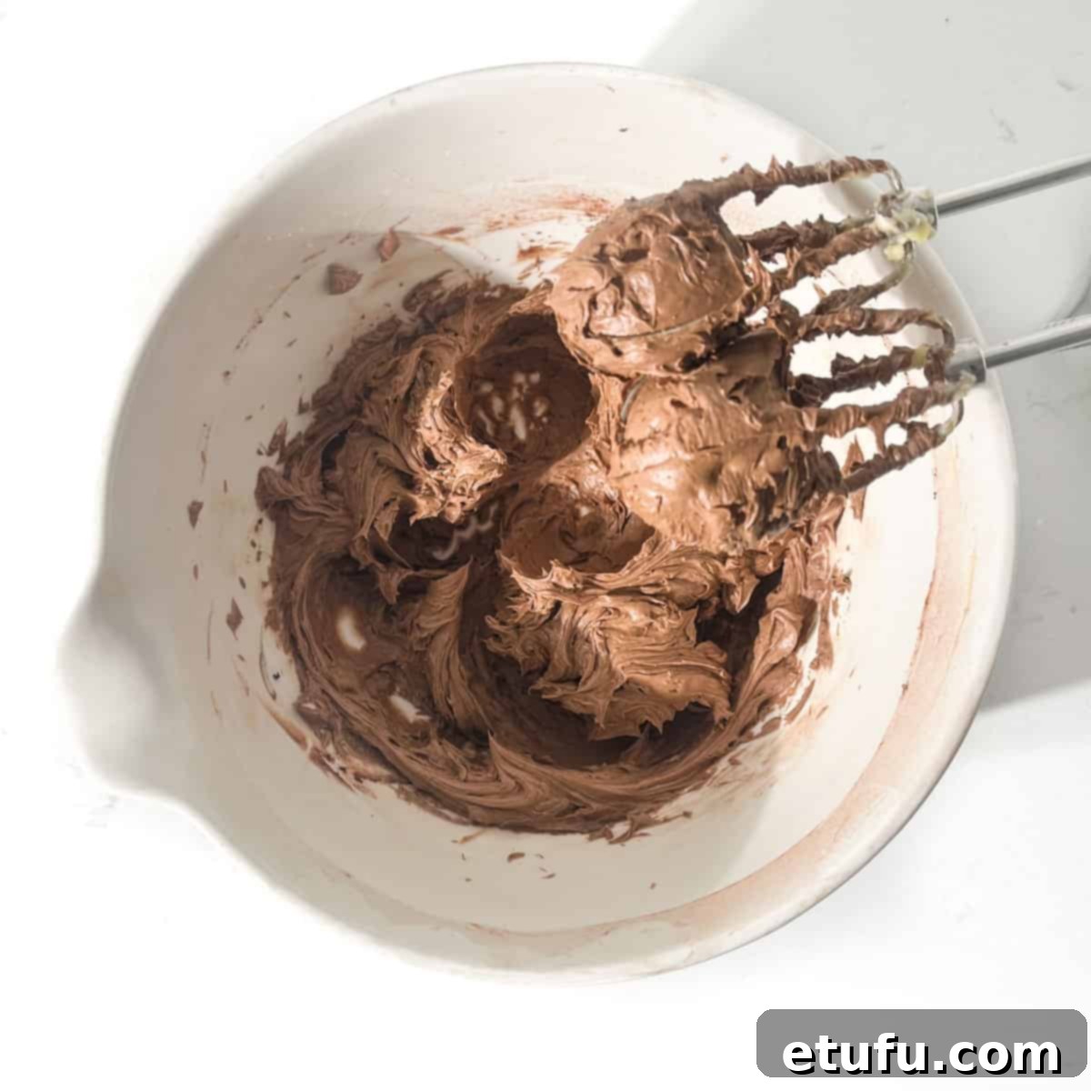 Mixing the cocoa powder into the butter and sugar mixture.