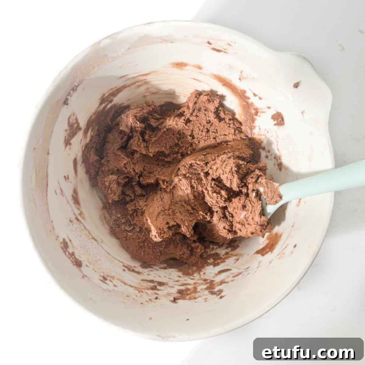 Mixing the flour into the butter and sugar mixture.