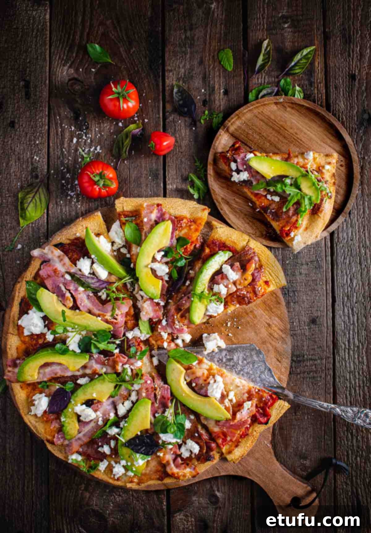 Quick Bacon Pizza with Creamy Avocado and Salty Feta 2 A large pizza on a wooden board, one slice of pizza to the side on a wooden plate