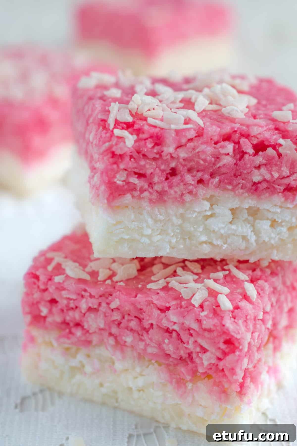 A few squares of coconut ice on a lace tablecloth.