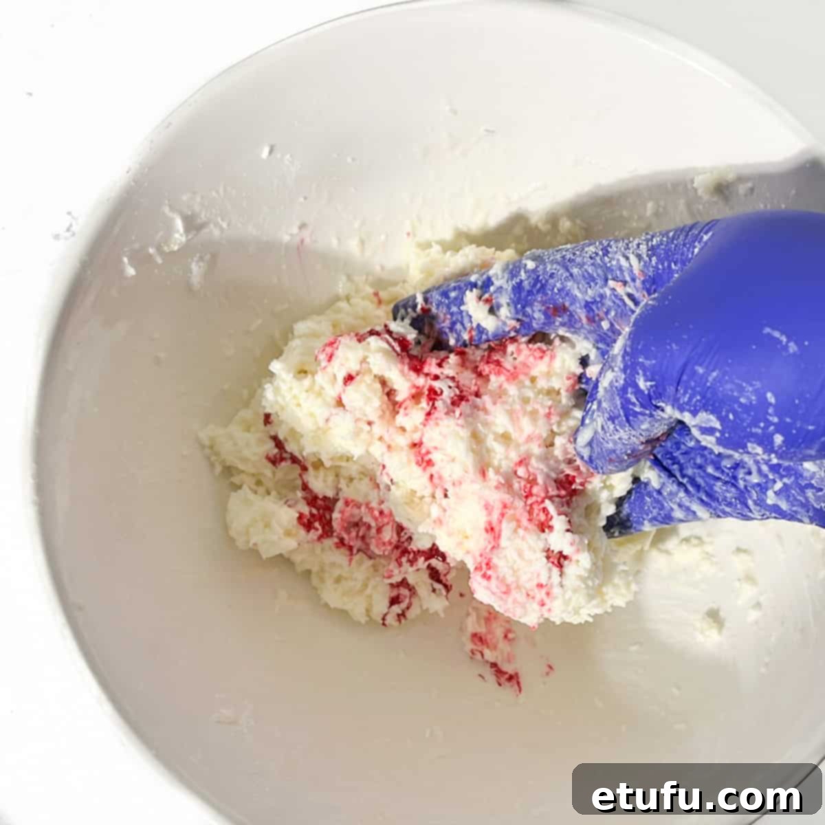 Mixing the pink food colouring into the second half of the coconut ice mixture.