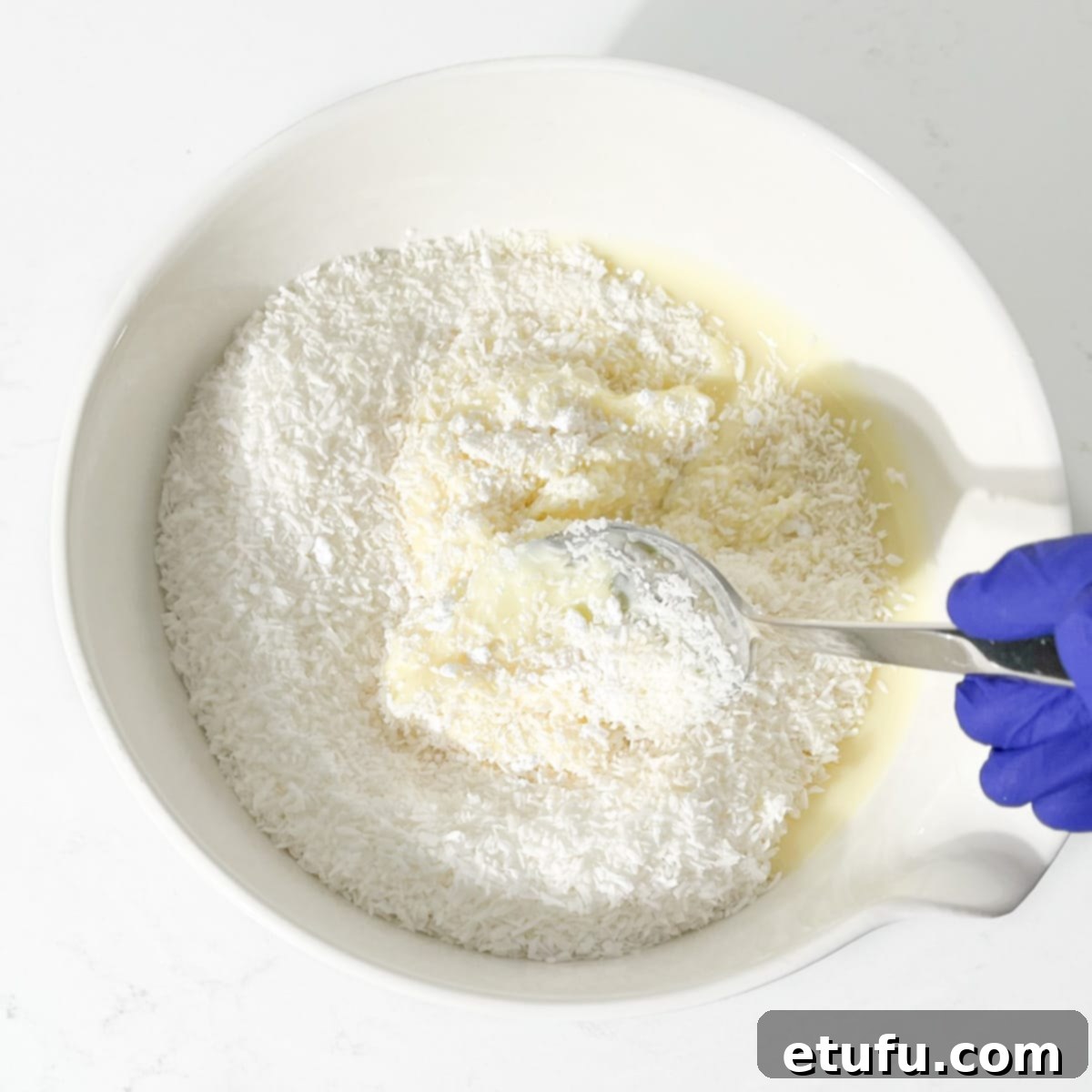 Mixing the mixture with a spoon.