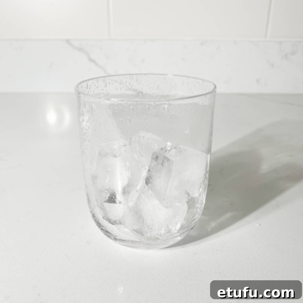 A glass filled with ice, ready for the Rock Shandy preparation.