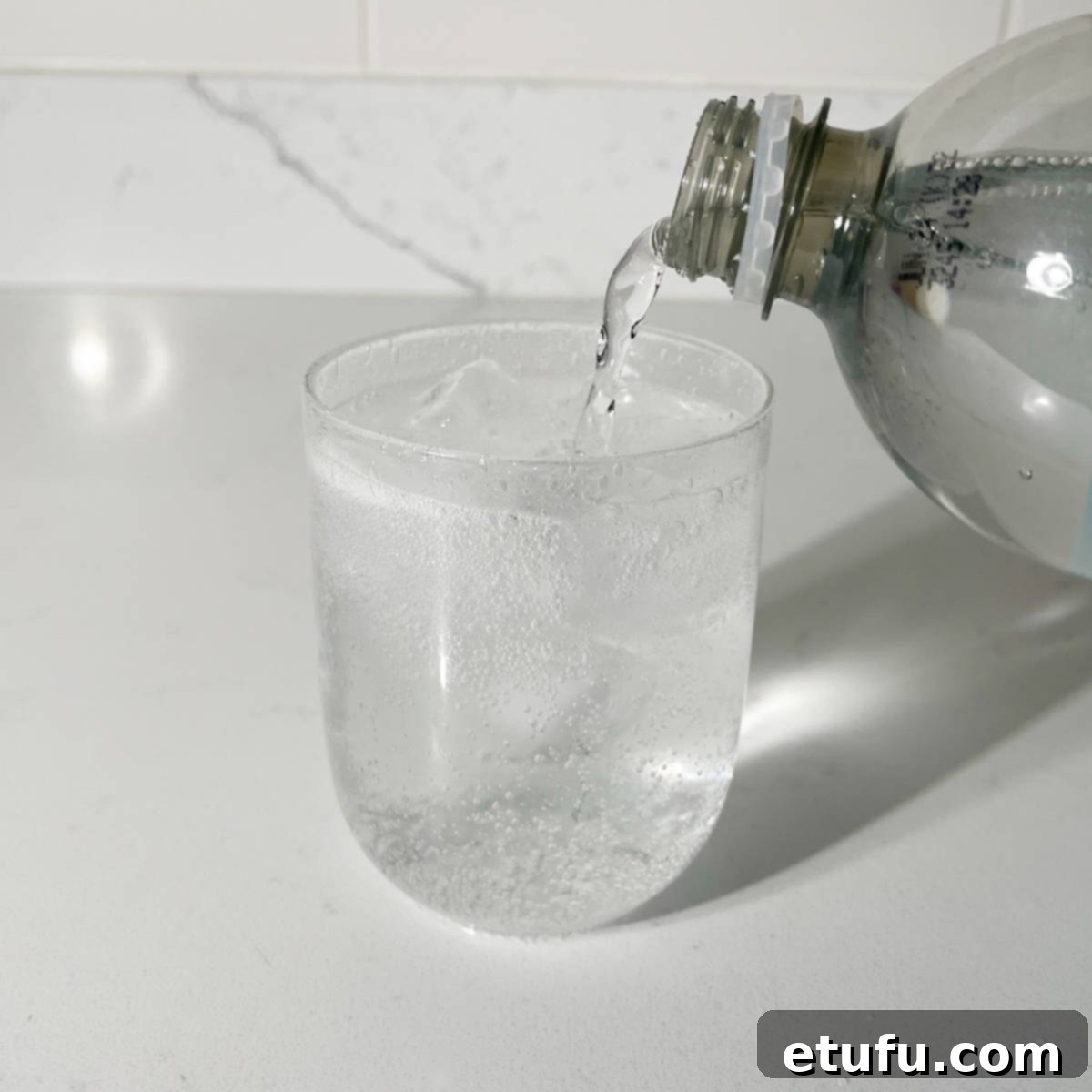 Adding lemonade to the rock shandy, creating a two-toned effect.