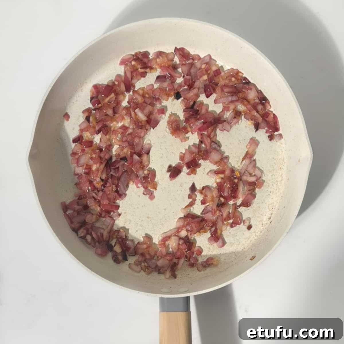 Perfectly caramelized onions with garlic and a touch of sugar in a frying pan, ready for the next step of the stuffing.