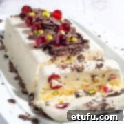 Exquisite Cassata ice cream adorned with glacé cherries, pistachios, and chocolate, elegantly presented on a pristine white serving plate.