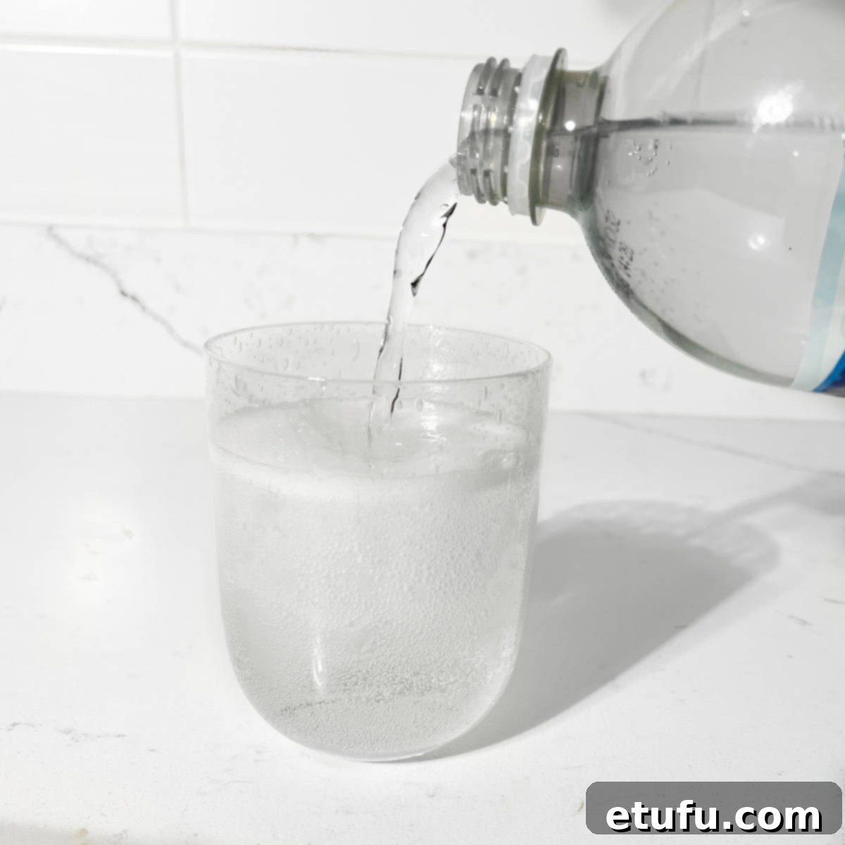 Pouring lemonade into glass.