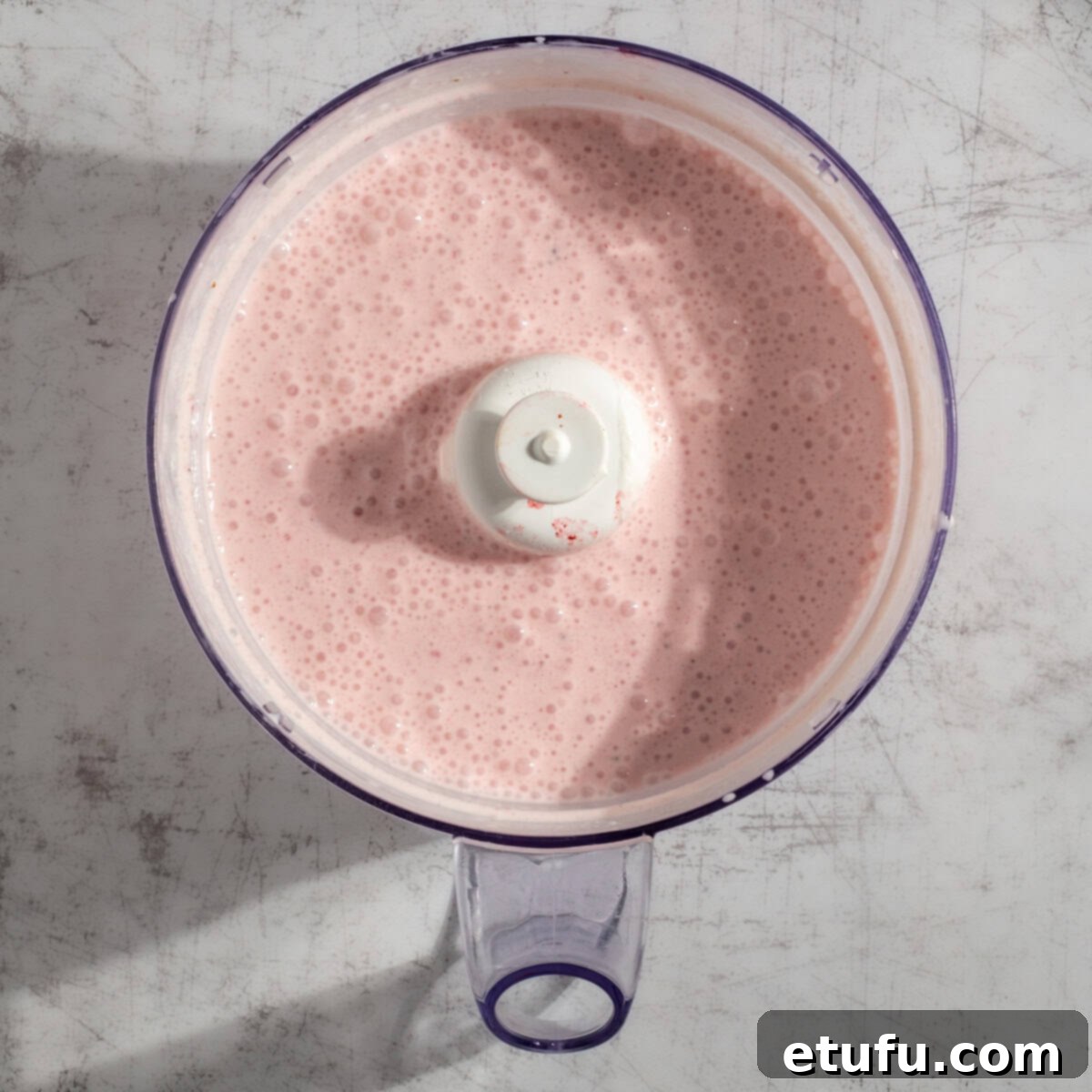 Creamy Strawberry Lassi 5 A blended strawberry lassi in a blender.