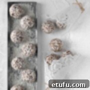 Date balls on a silver tray and white tablecloth.