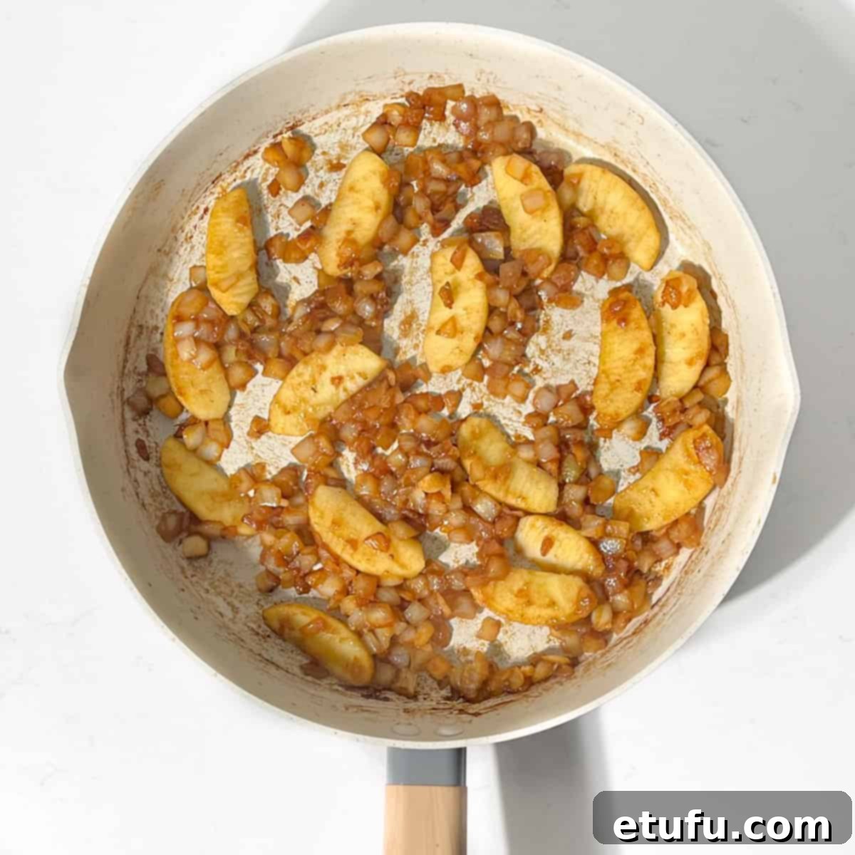 Ultimate Devilled Sausages 11 Fried onions, apples and garlic in a large frying pan.