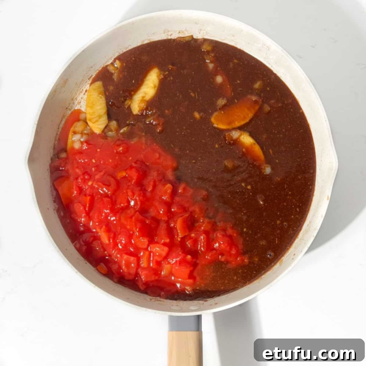Ultimate Devilled Sausages 12 Adding the tomatoes and sauce to the pan.