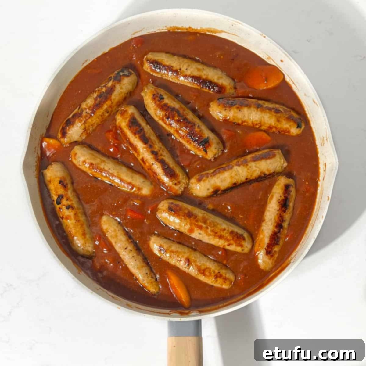 Ultimate Devilled Sausages 14 Adding the sausages back in the pan with the sauce.