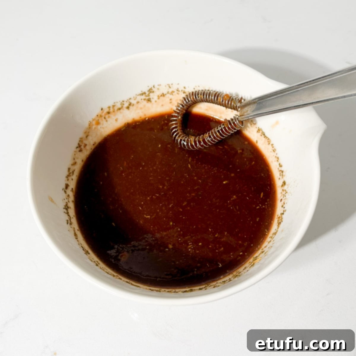 Ultimate Devilled Sausages 7 Whisking together the devilled sausages sauce.