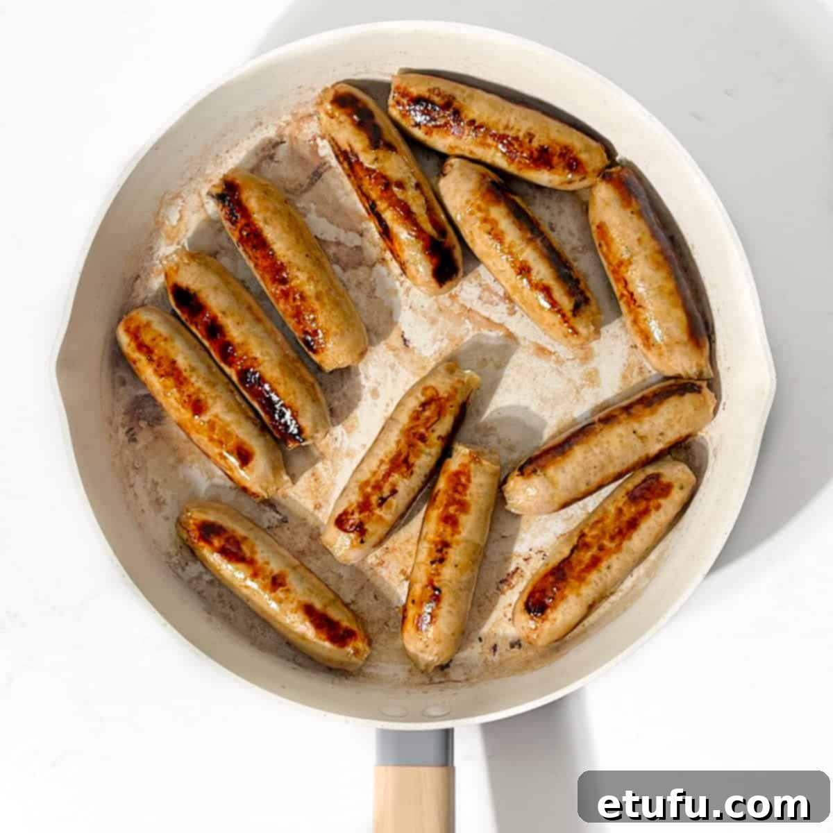 Ultimate Devilled Sausages 8 Frying the sausages in a large pan.