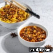 A bowl of crispy chilli oil alongside a bowl of egg noodles, highlighting its delicious versatility.