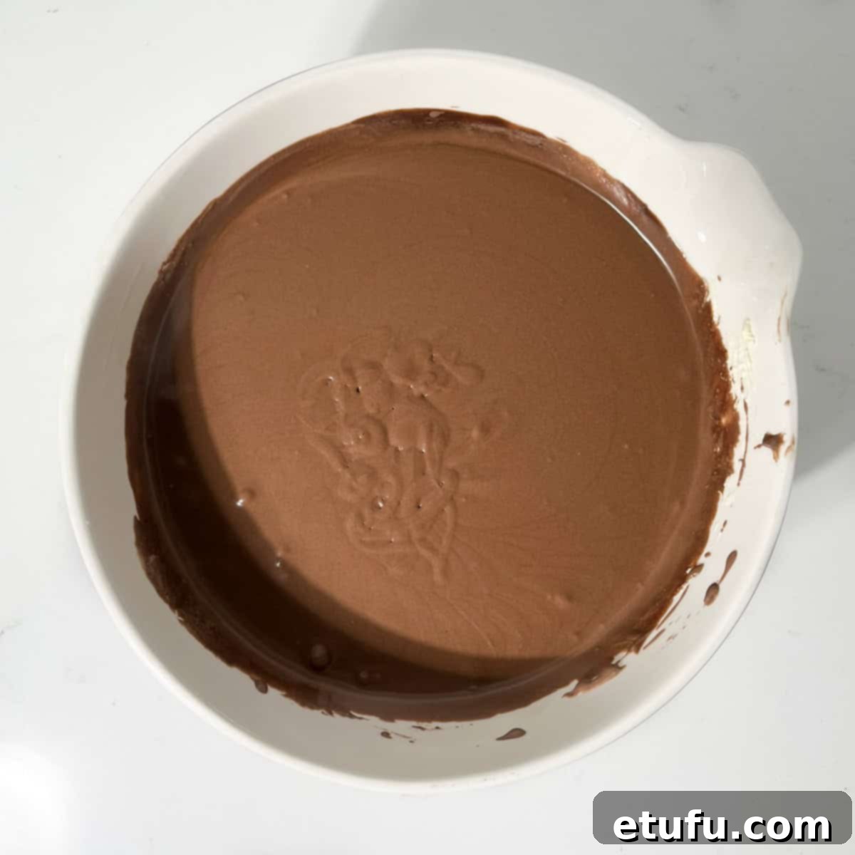 The final smooth mixture for dark chocolate ice cream in a large white bowl, ready for freezing.
