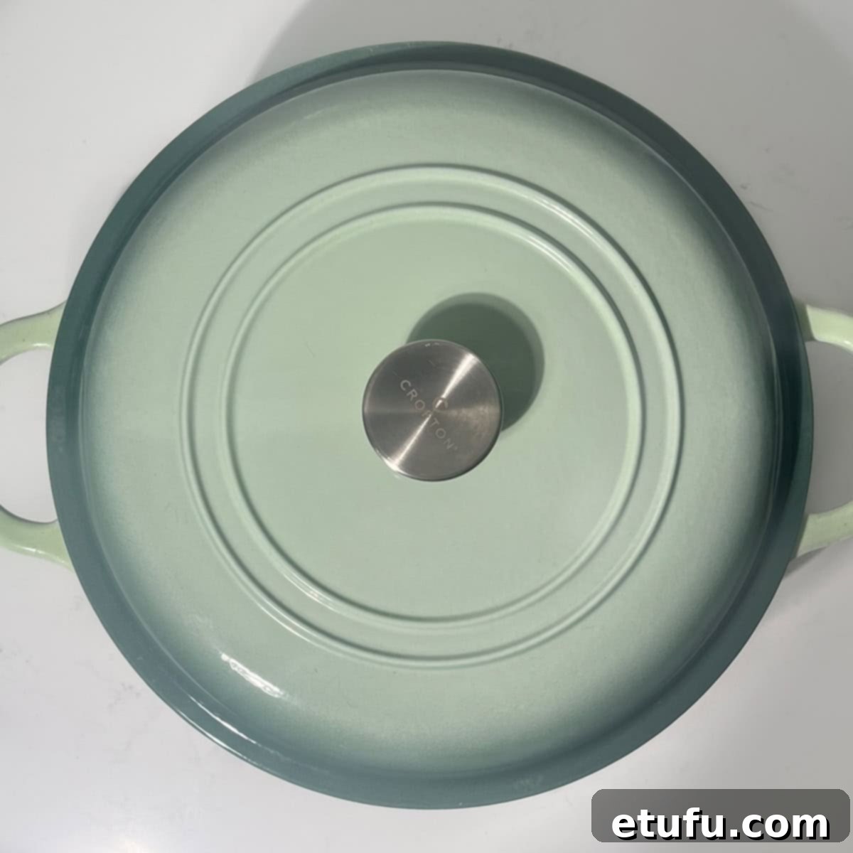 A large green saucepan with a lid on, allowing the pasta to rest.