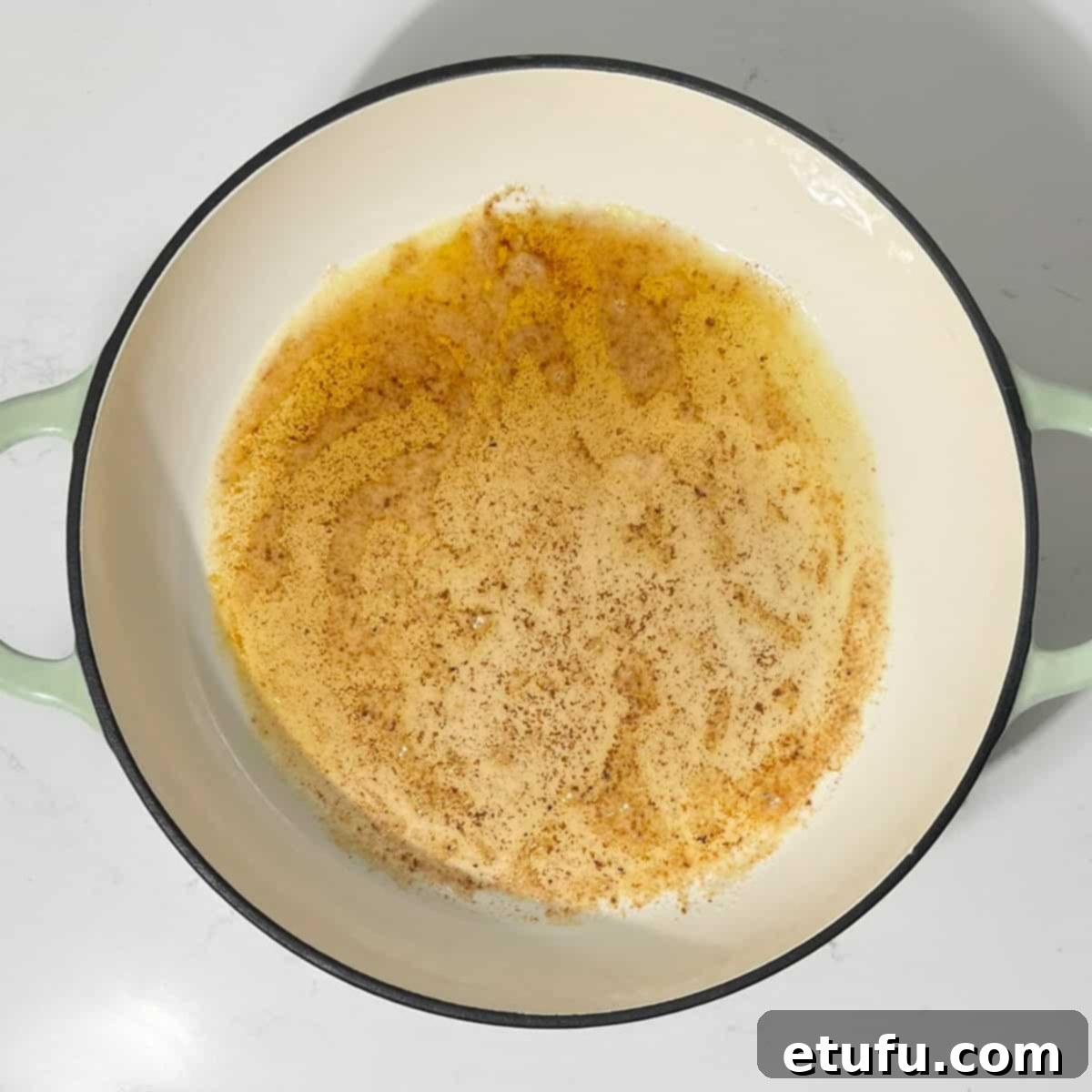 Browned butter in a large frying pan, ready for the onions.