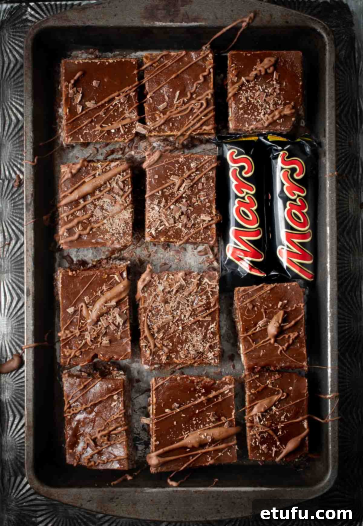 Mars bar slices on a baking sheet with two small Mars bars.