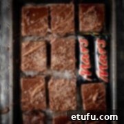 Mars bar slices on a baking sheet with two small Mars bars.
