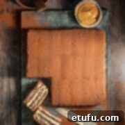 A classic Chocotorta, Argentinian no-bake chocolate cake, with a slice removed, revealing its delicious layers of chocolate biscuits and creamy dulce de leche filling.