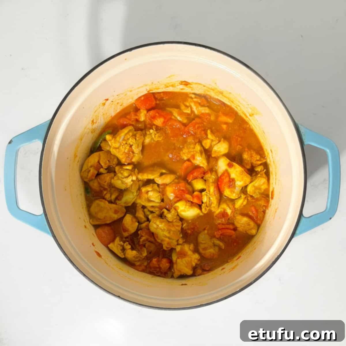 Cooked chicken karahi curry in a large saucepan.