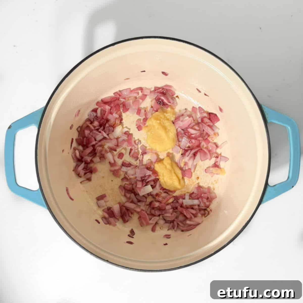 Adding garlic and ginger to the fried onions.