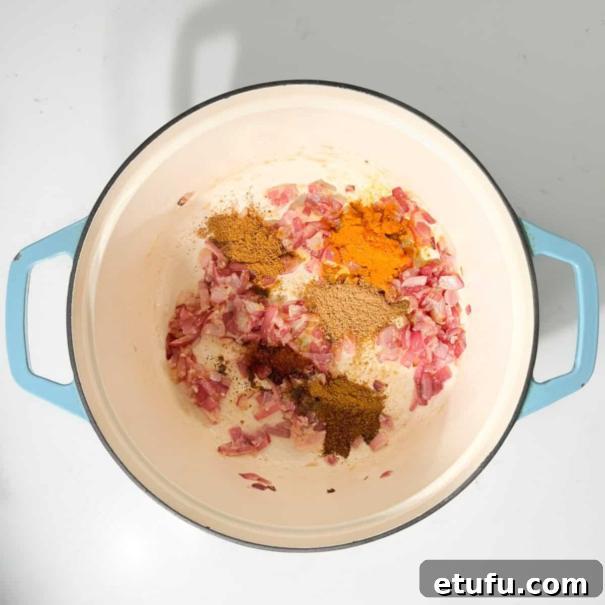 Adding the spices to the fried onions.