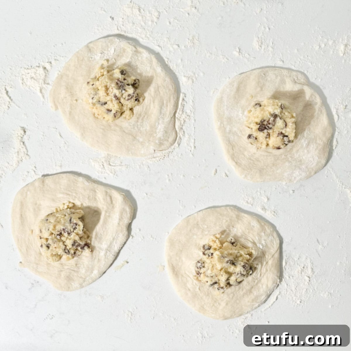 Dividing the sweet Peshwari filling equally among four flattened dough portions.