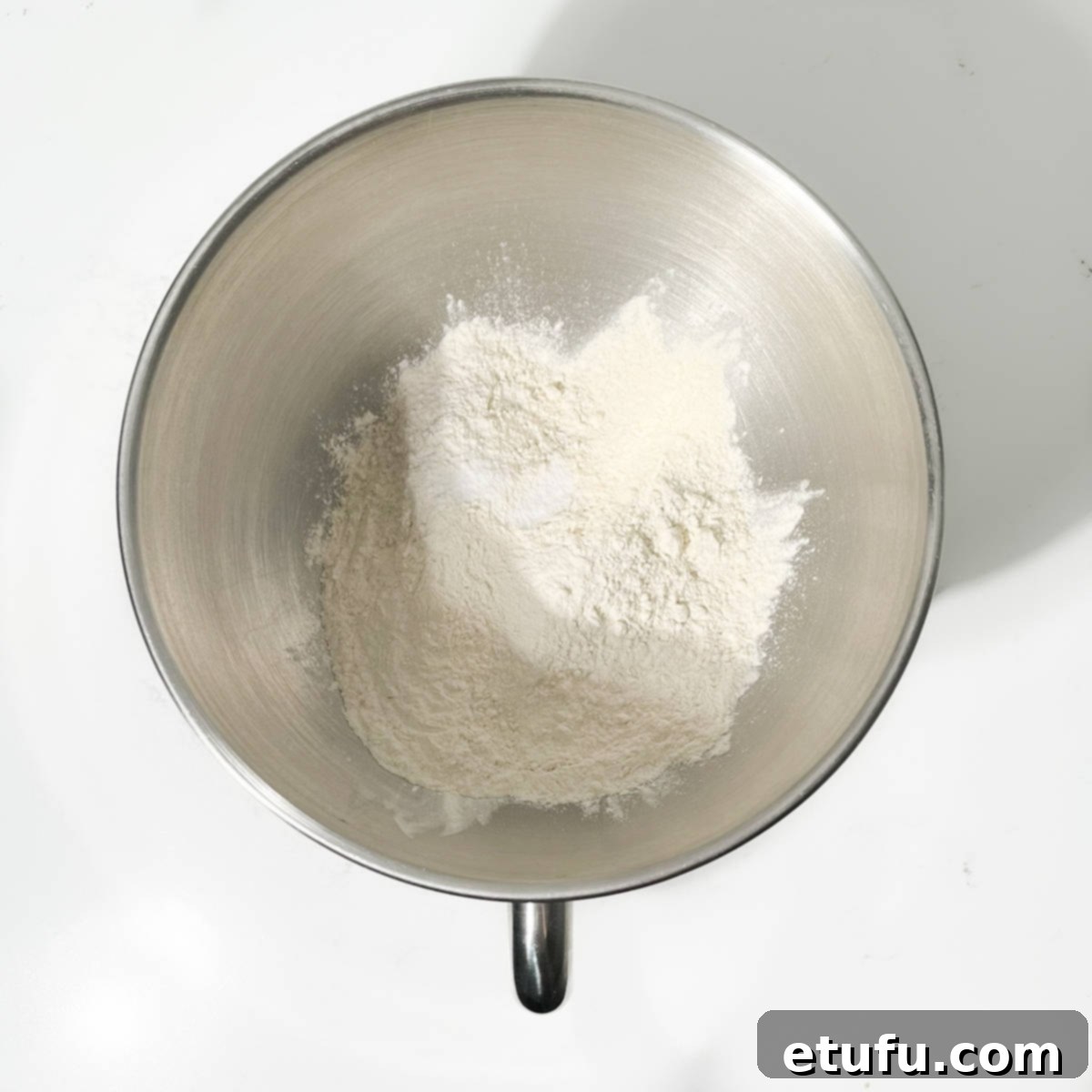 Adding all-purpose flour and salt to the large bowl of a stand mixer.