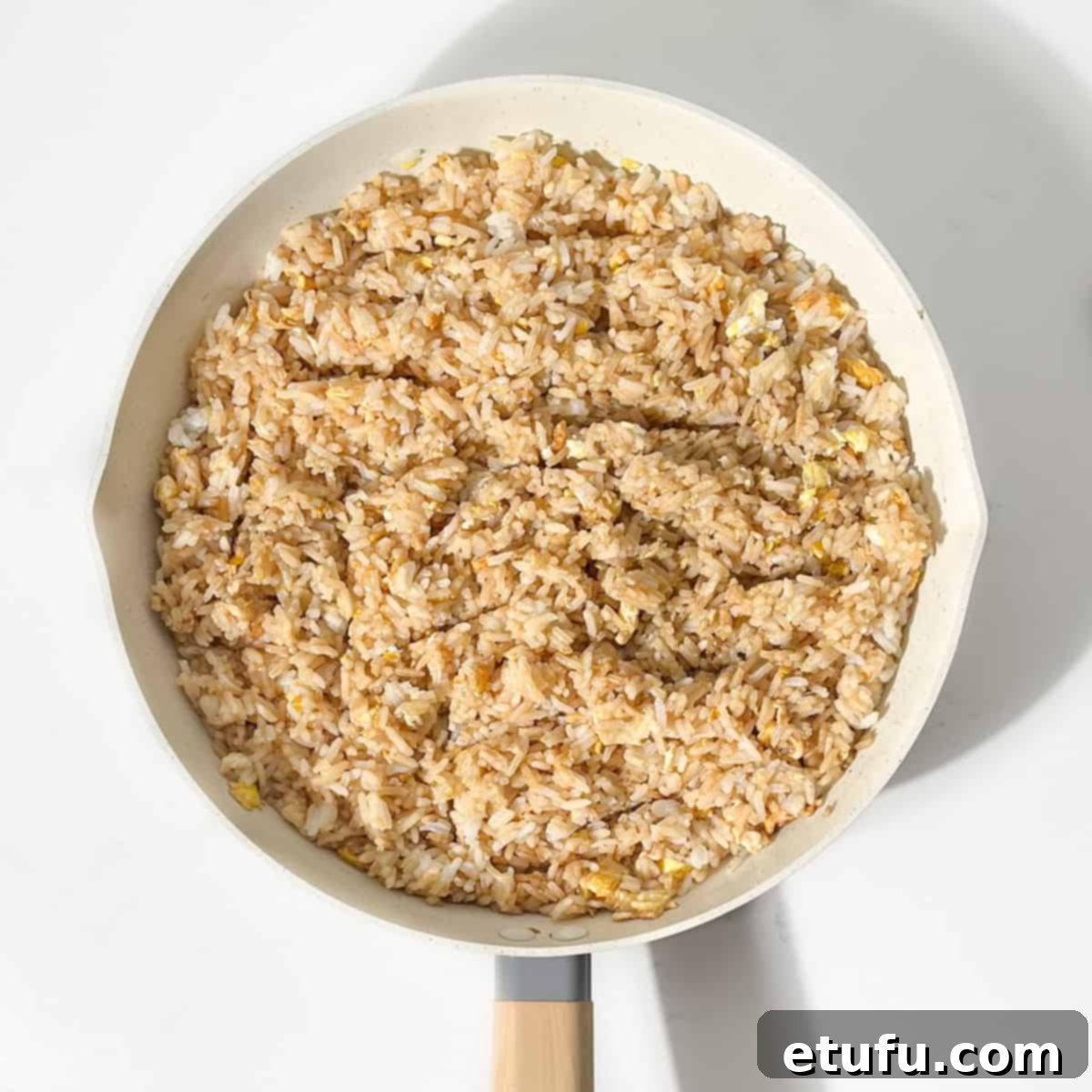 Combining the rice with the sauces and garlic and ginger.