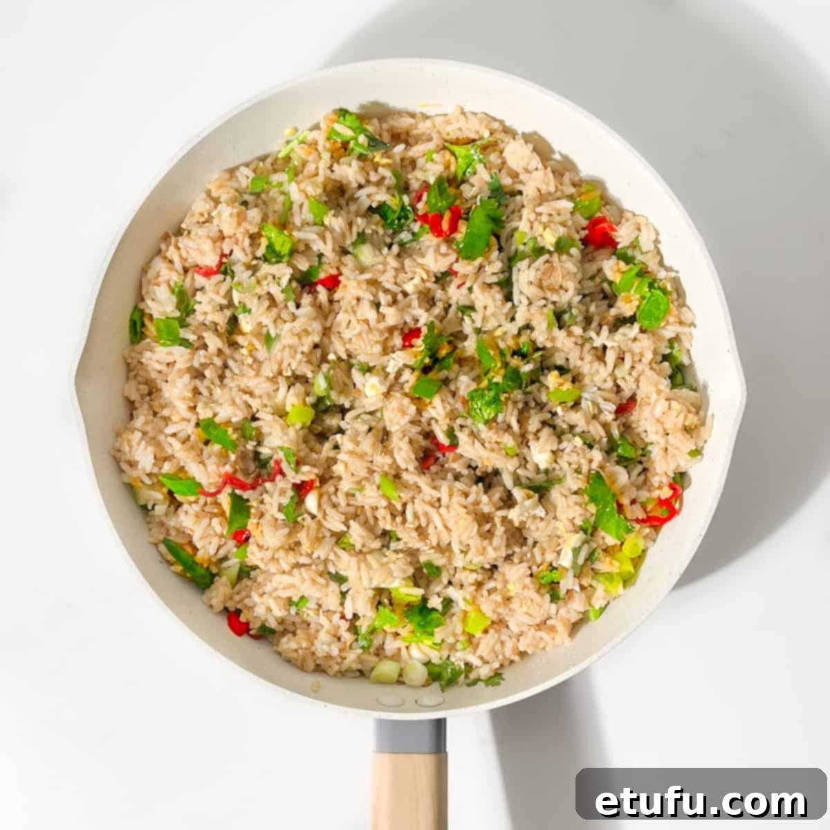 Cooked khao pad in a large frying pan.