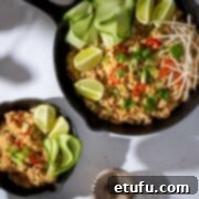A large cast iron pan with Khao pad and a small serving dish with a helping of khao pad.