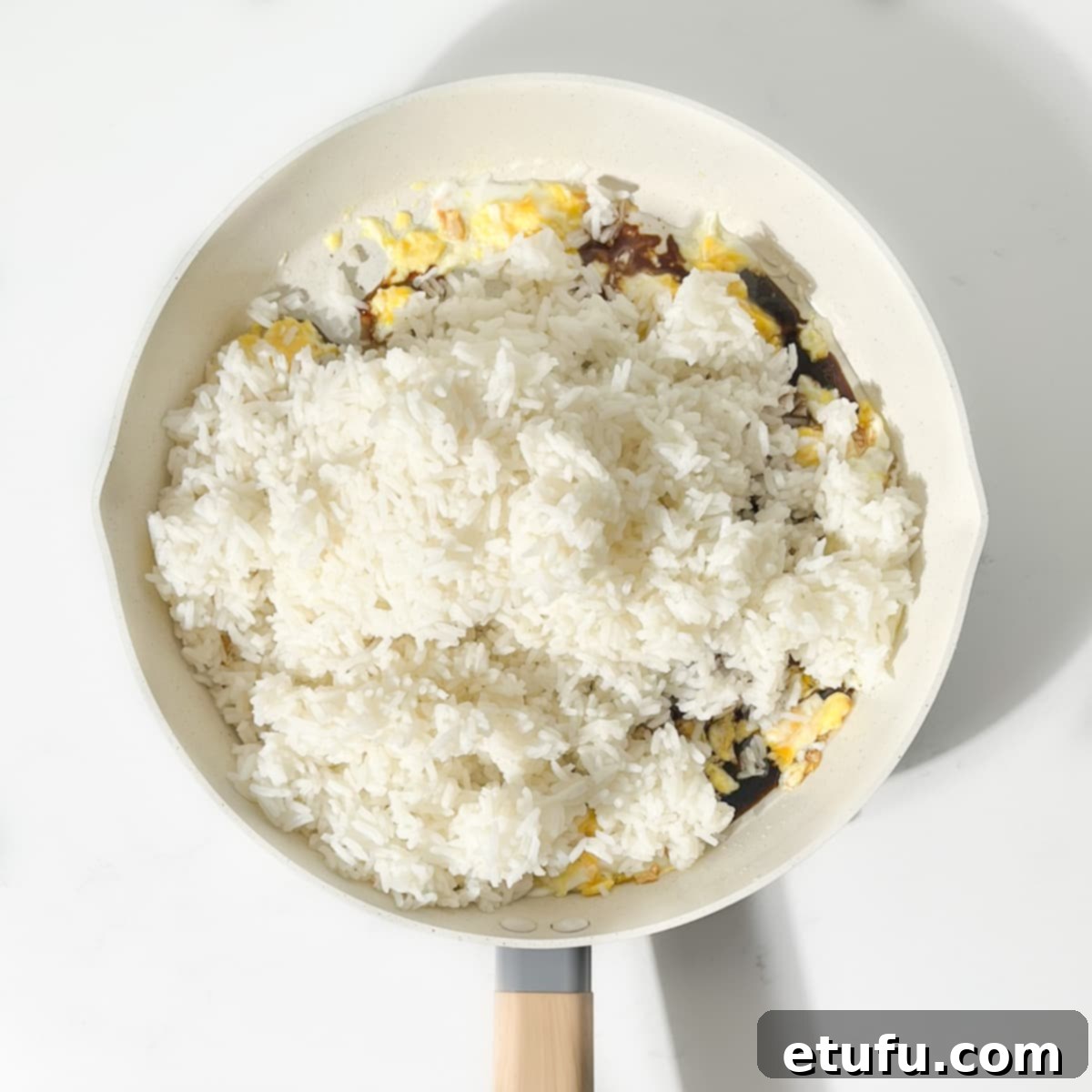 Adding the rice to the pan.