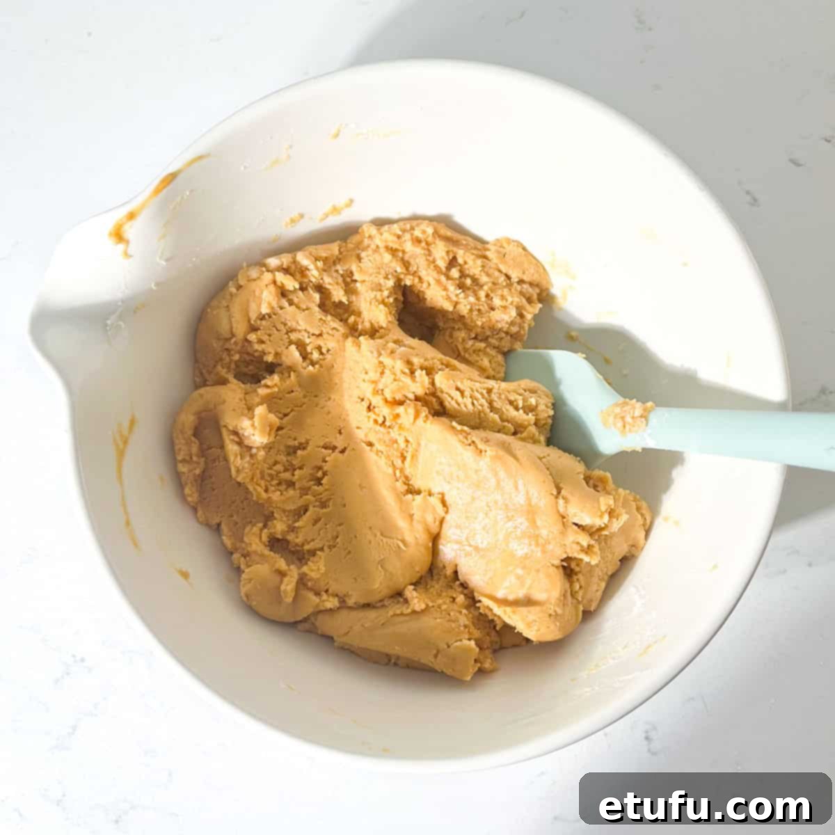 The peanut butter fudge mixture ready to be added to the square pan.