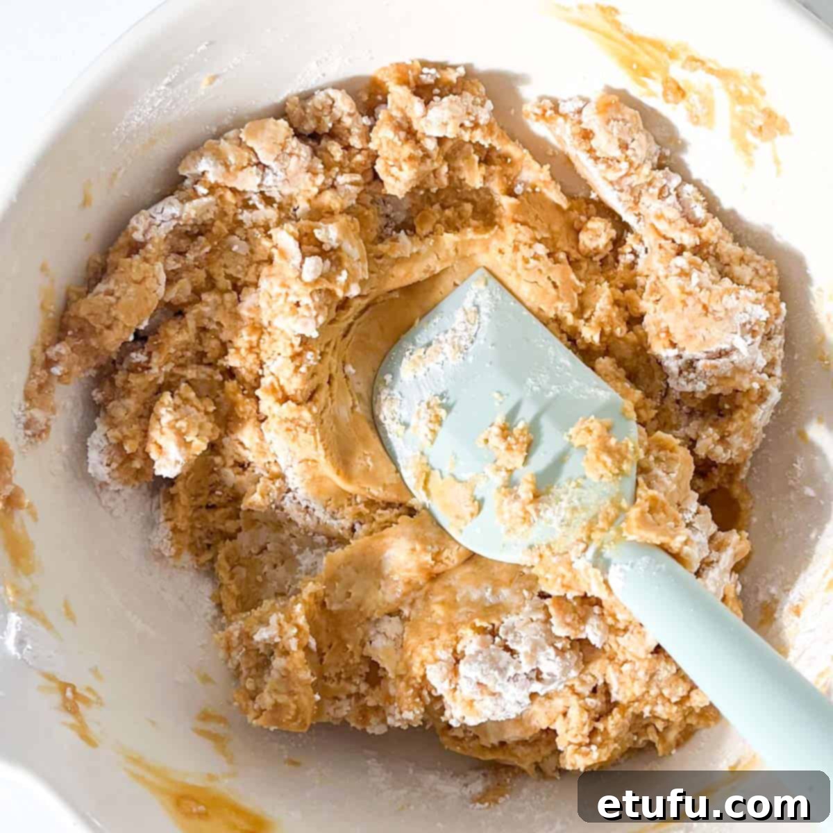 Combining the icing sugar with the melted butter and peanut butter.