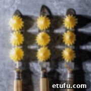 Perfectly piped butter rosettes gracing three vintage knives, highlighting elegant serving ideas.