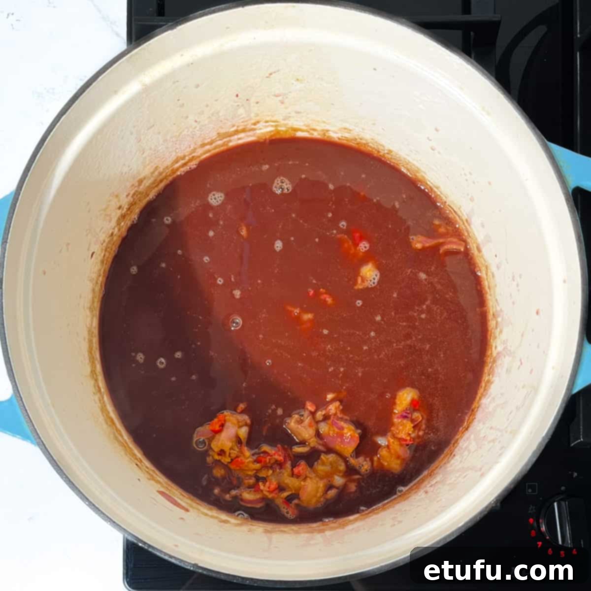 Adding the Trinchado sauce to the saucepan.