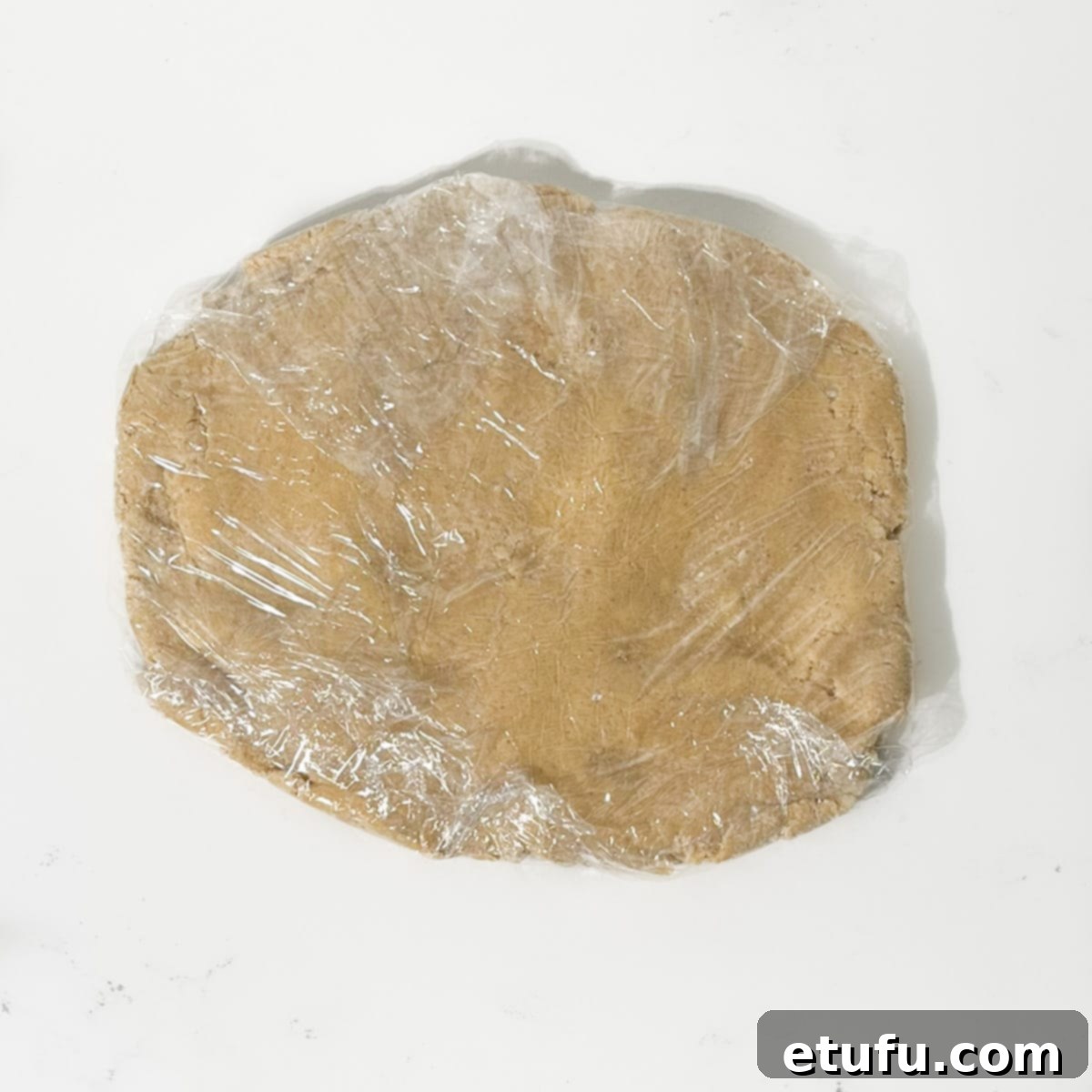 Spice biscuits mixture wrapped in cling film.