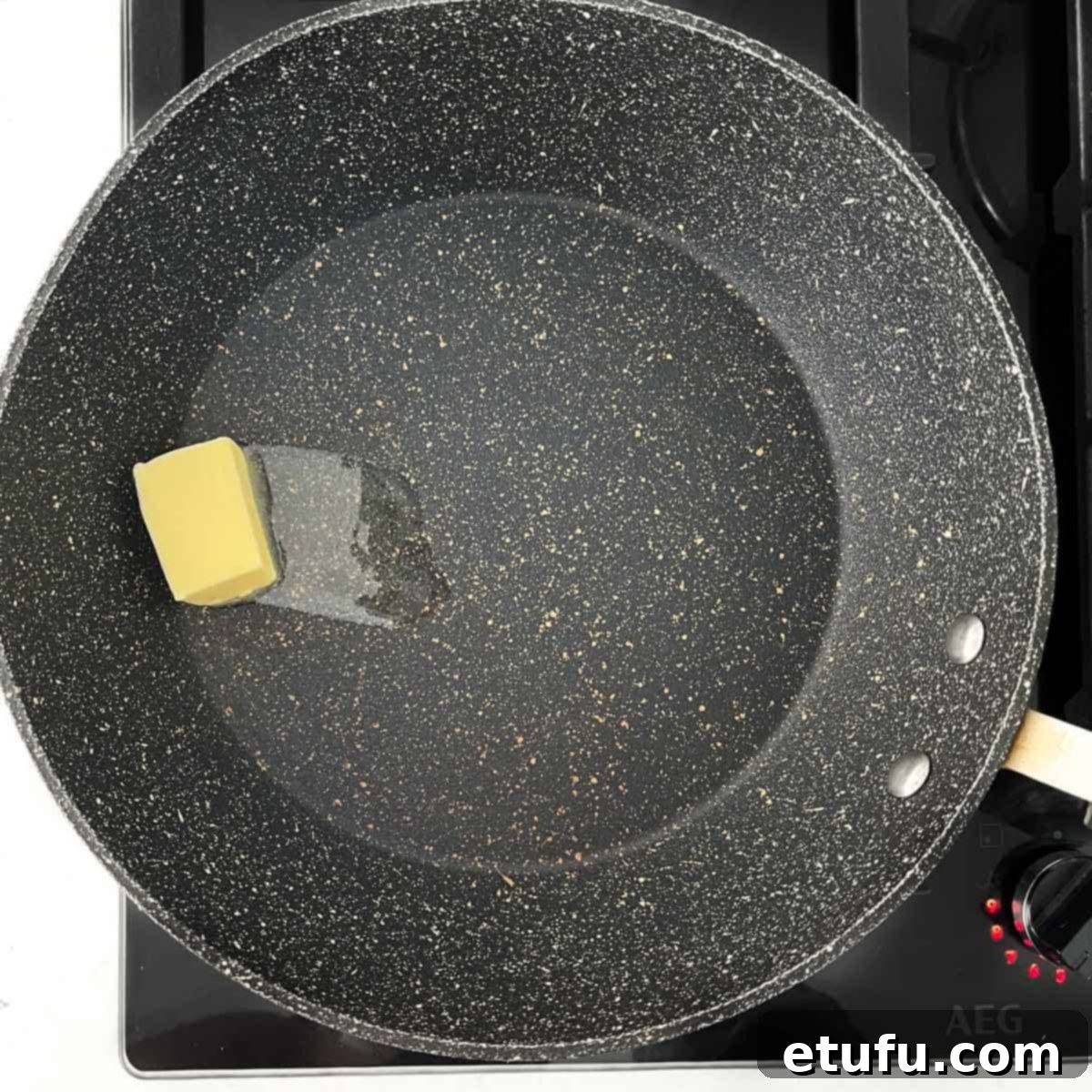 Butter melting in a large frying pan over medium heat.