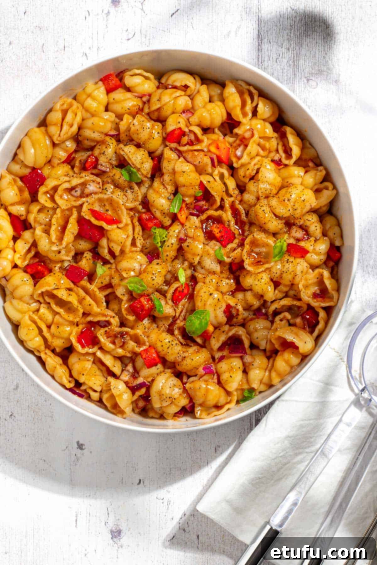 Curry noodle salad in a large white bowl. 