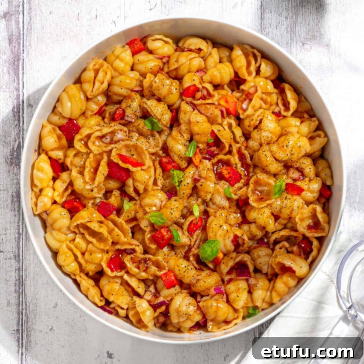 Curry noodle salad in a large white bowl.